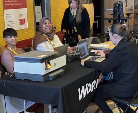 Staff from Pierce County WorkSource offices help a job seeker with their resume at the job fair.