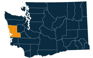 A dark blue map of Washington state with Grays Harbor County highlighted in orange.