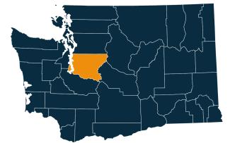 A dark blue map of Washington state with King County highlighted in orange.