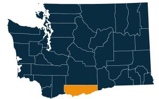 A dark blue map of Washington state with Klickitat County highlighted in orange.