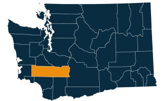 A dark blue map of Washington state with Lewis County highlighted in orange.