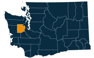 A dark blue map of Washington state with Mason County highlighted in orange.