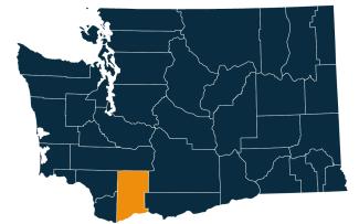 A dark blue map of Washington state with Skamania County highlighted in orange.