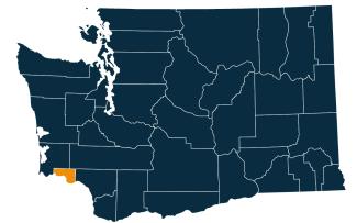 A dark blue map of Washington state with Wahkiakum County highlighted in orange.