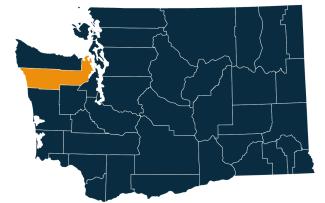 A dark blue map of Washington state with Jefferson County highlighted in orange.