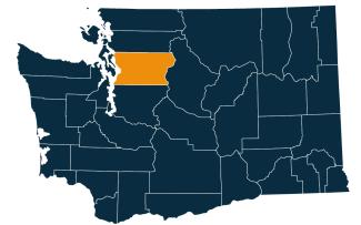 A dark blue map of Washington state with Snohomish County highlighted in orange.