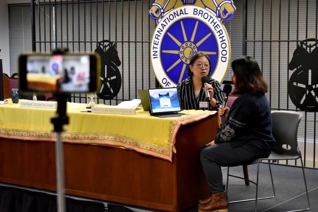Representatives from the Chinese Information and Service Center conduct a role-play during their presentation at the UI Navigators summit in December